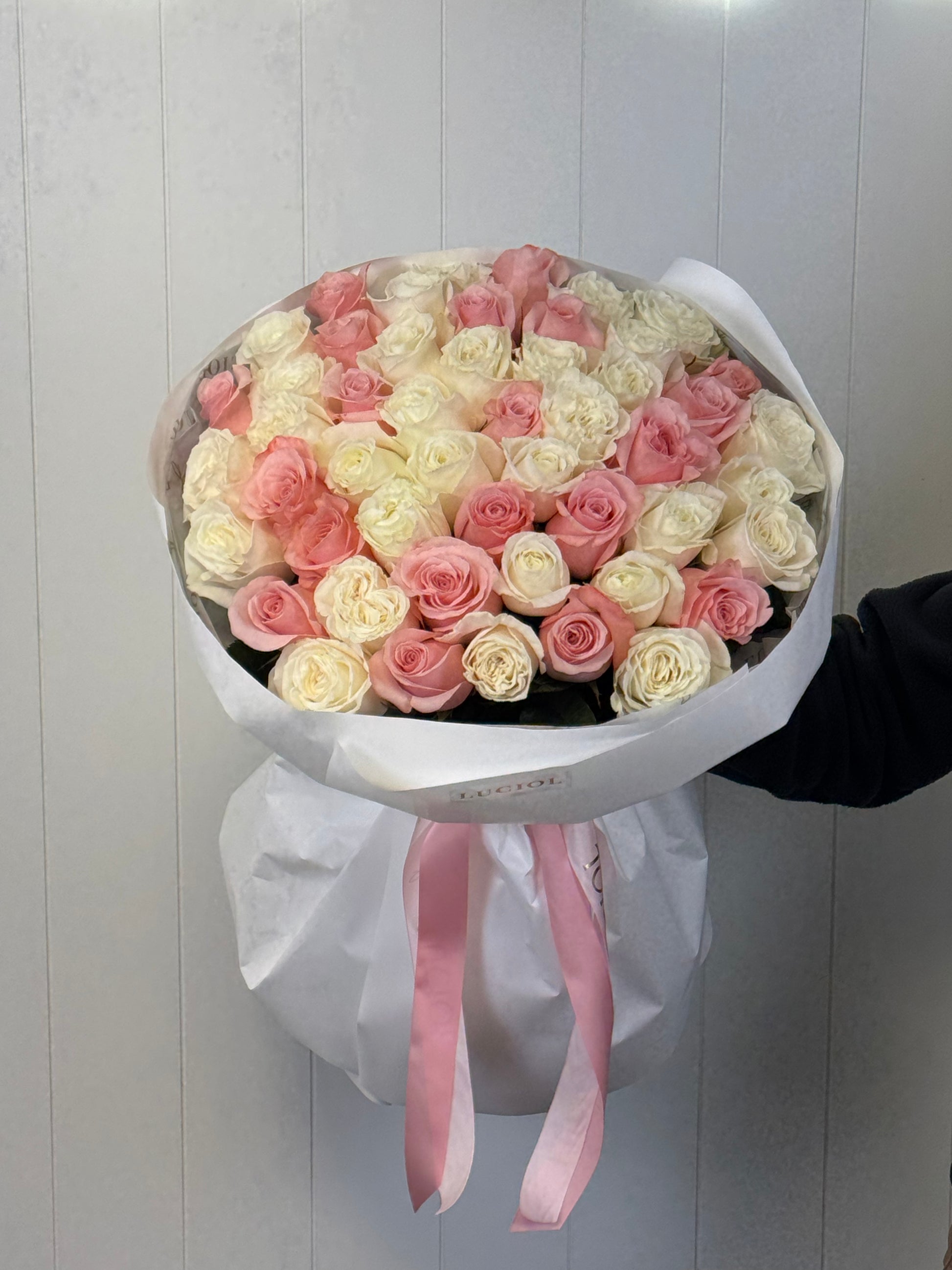 White and pink roses bouquet in elegant white wrapping by Luciol Bouquets – flower delivery Seattle and Bellevue