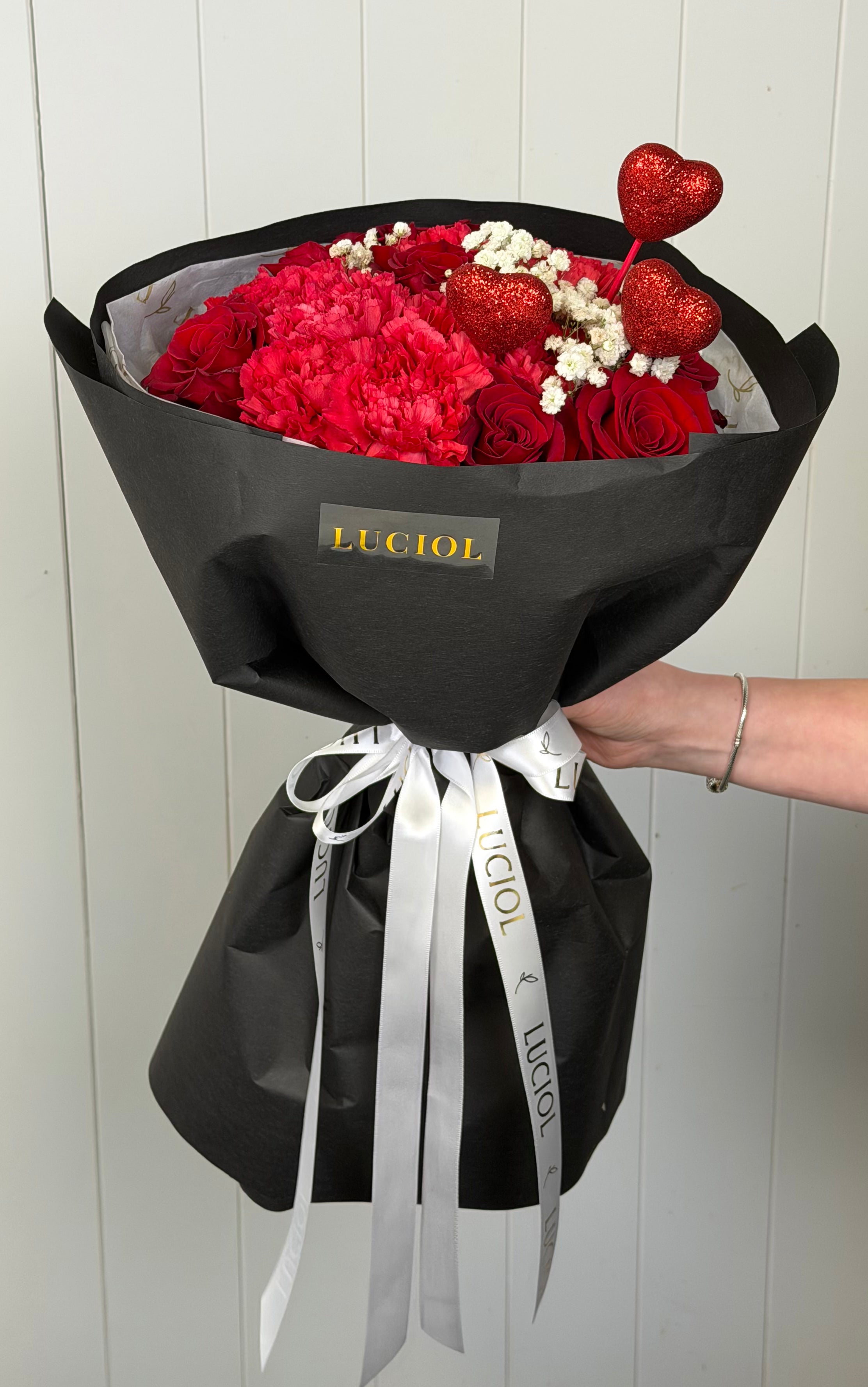 Three small heart accents placed on a bouquet, adding a soft and romantic touch.
